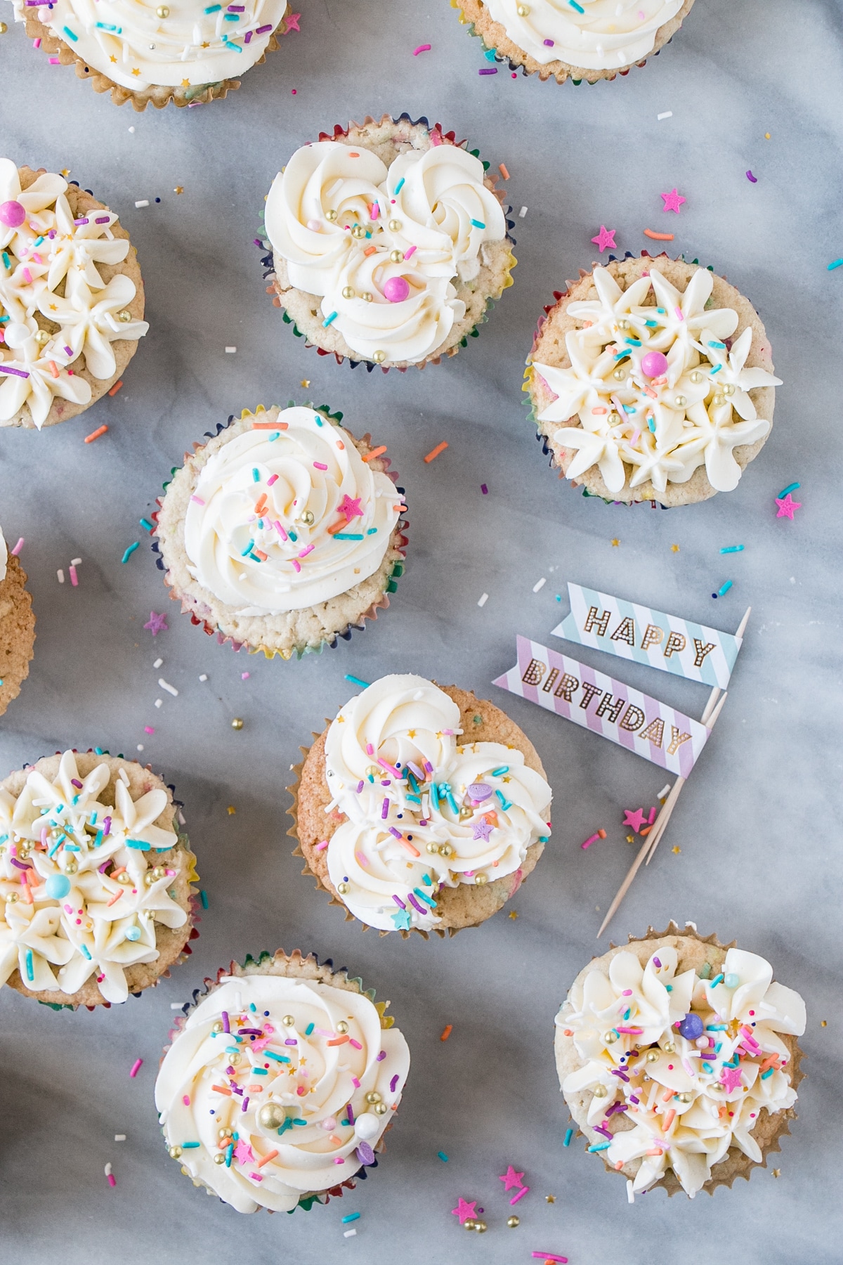 Momofuku Milk Bar Cake turned Birthday Cupcakes. Top down photo with sprinkles.