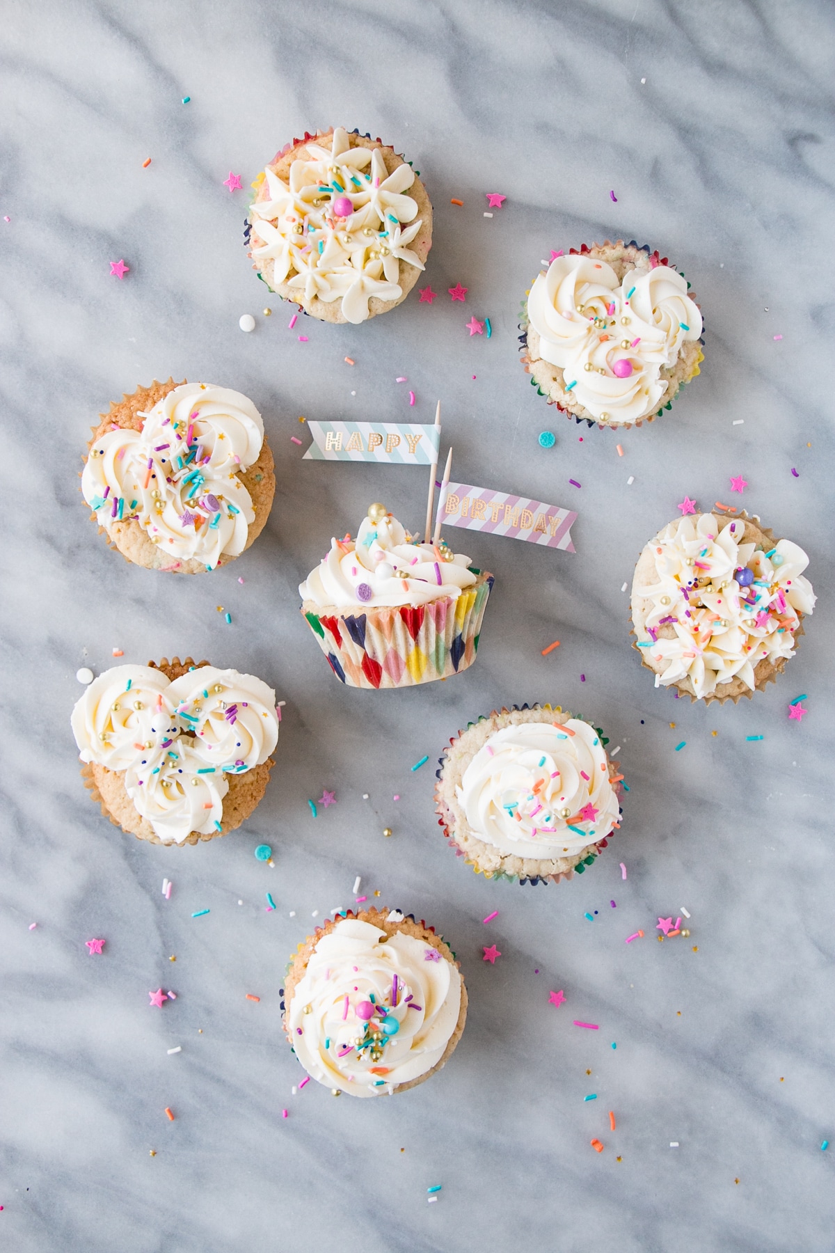 Momofuku Milk Bar Cake turned Birthday Cupcakes. Top down photo with sprinkles.