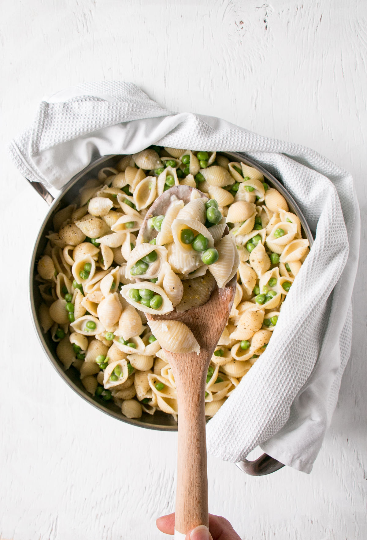 Lemon Pepper Alfredo in a large serving spoon over top of a skillet