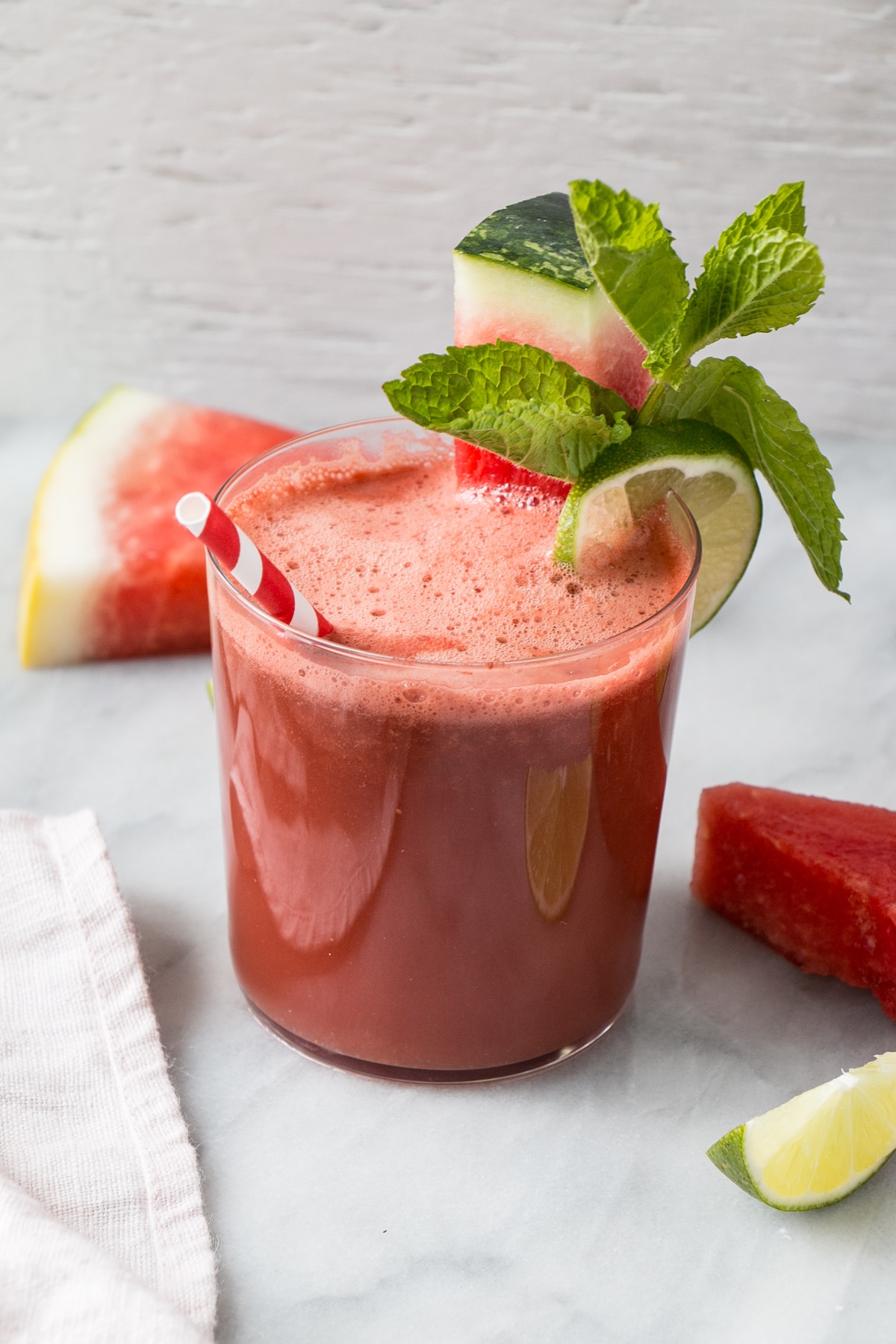 watermelon smoothie with watermelon mint and lime garnishes in glasses 
