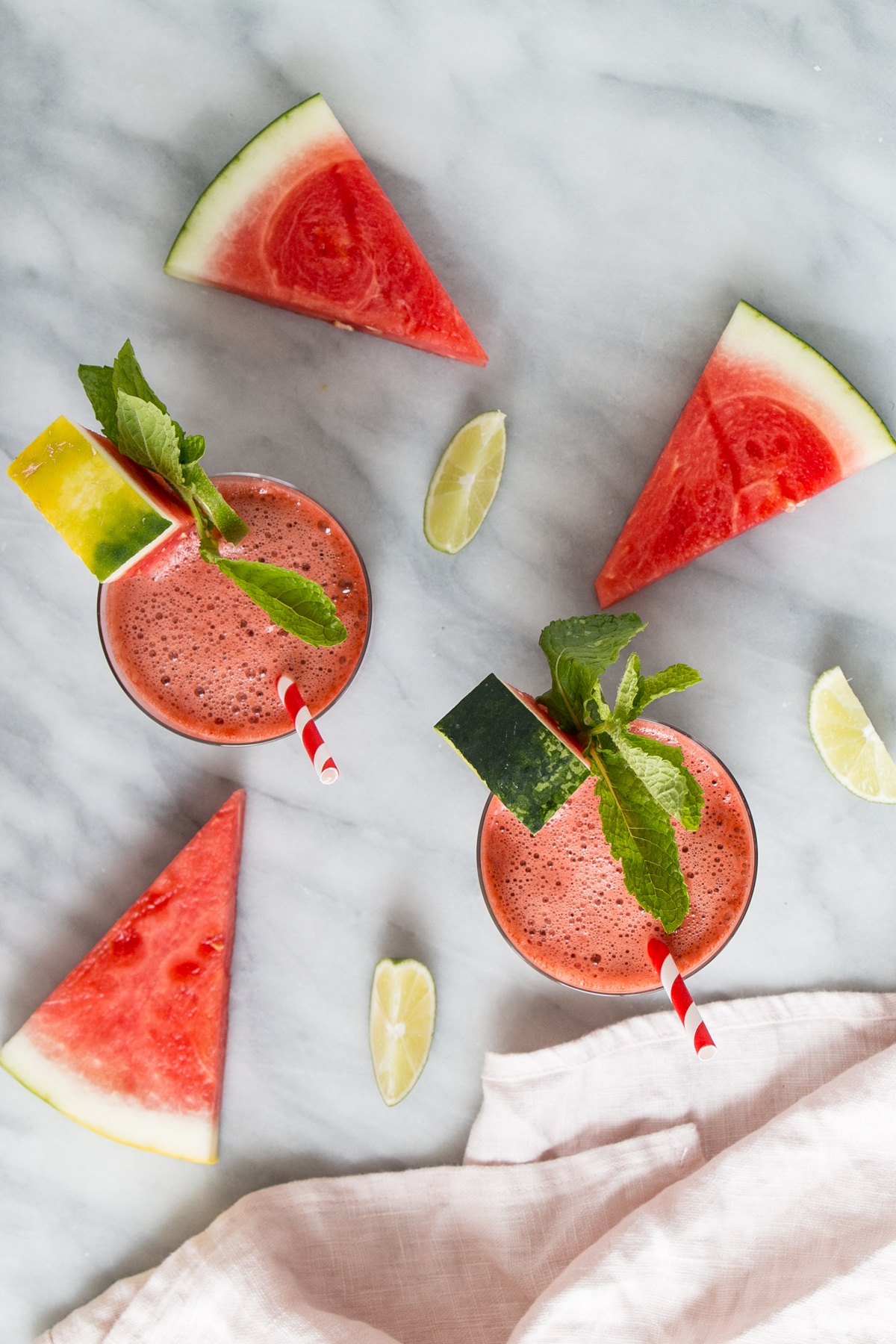watermelon smoothie with watermelon mint and lime garnishes in glasses