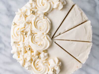 Up close, top down photo of a creamy, rose piped, Vanilla Bean Champagne Cake