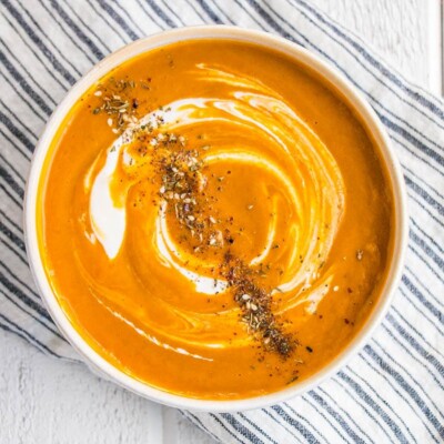 Deeply orange hued Roasted Carrot Soup with a switl on thick yogurt and topped with a Za'atar spice blend.