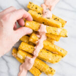 polenta fries in a pile with smoky tomato dip