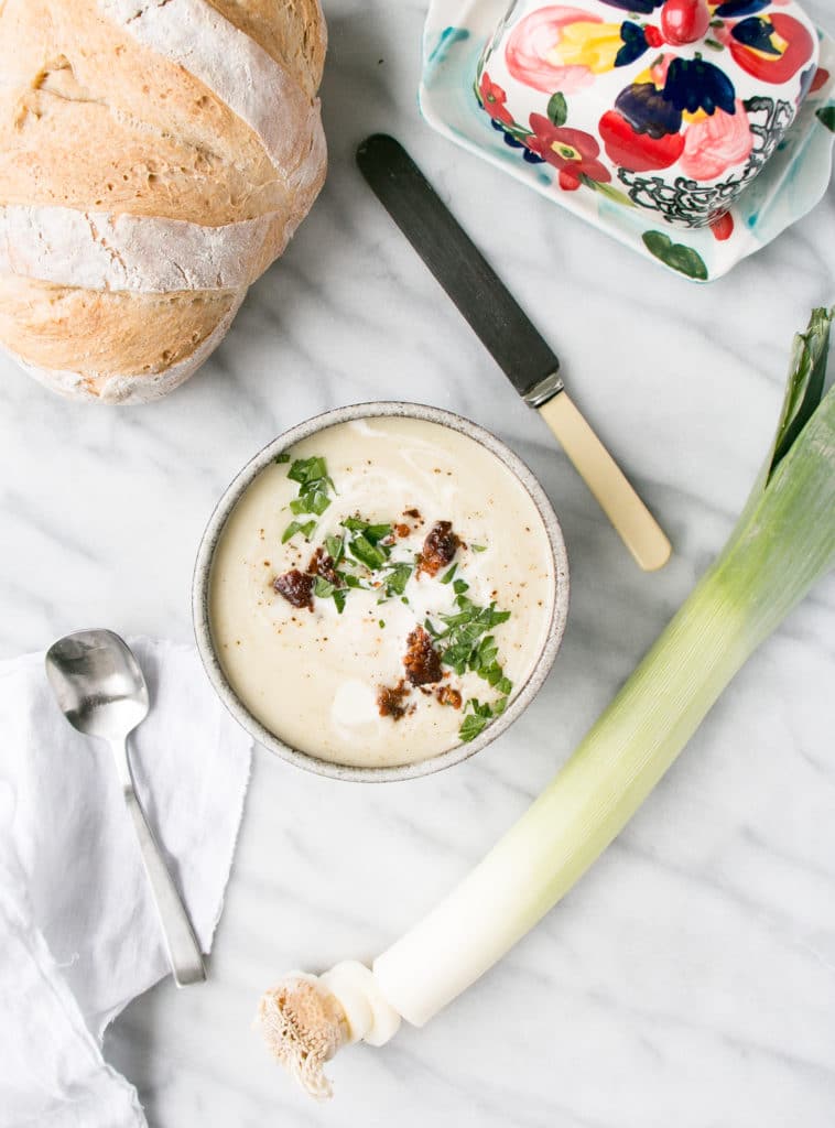 slow cooker cream of leek soup in a bowl w/ crispy chorizo bits