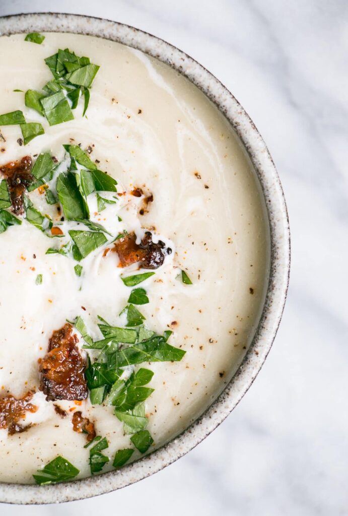 slow cooker cream of leek soup in a bowl w/ crispy chorizo bits