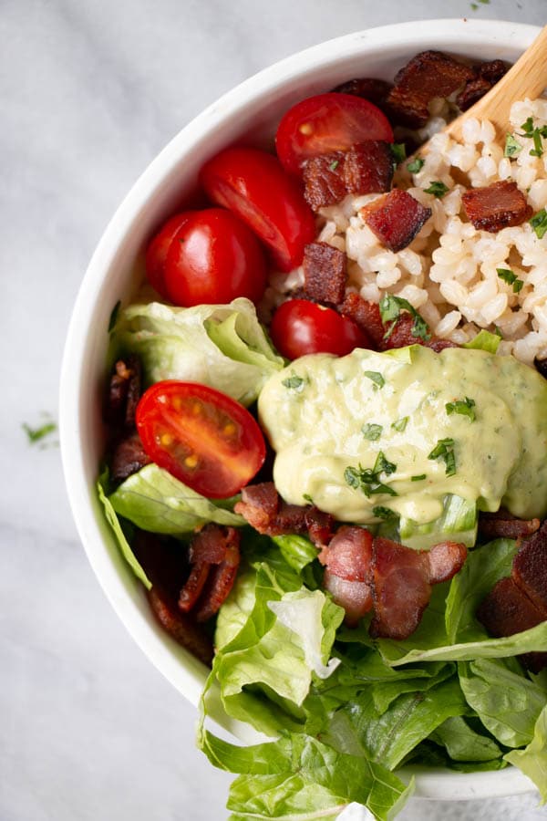 BLT Rice Bowl recipe with a thick Avocado Lime Dressing in a white bowl