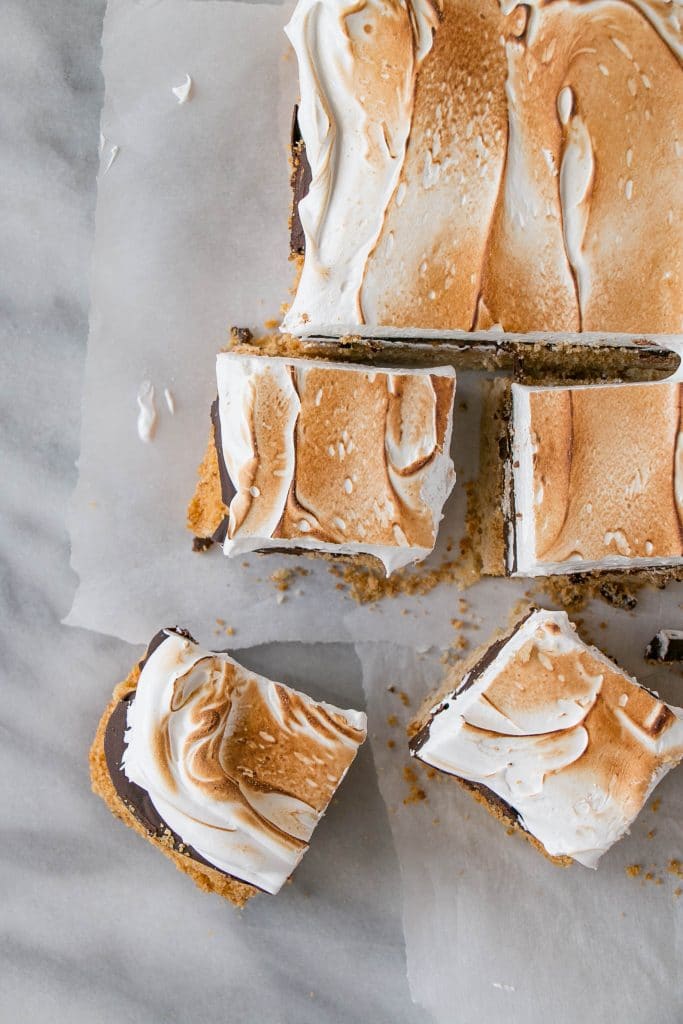 S'mores Blondies are the perfect treat! A layer of graham cracker blondies, chocolate ganache, and marshmallow fluff.
