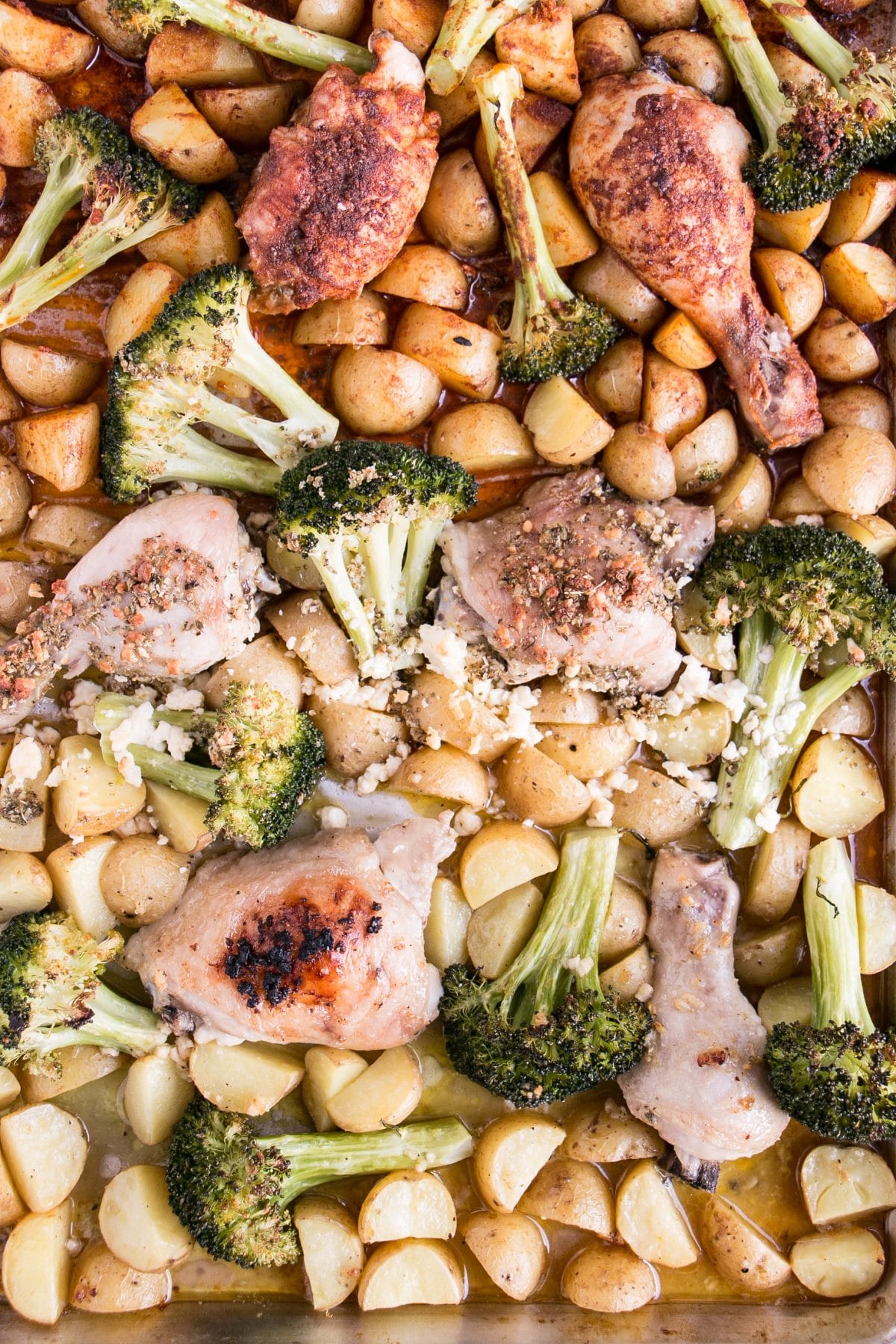 Sheet Pan Chicken, Potatoes and Broccoli 3 Ways with Oregano Feta, Lemon Garlic, and Sweet Paprika. Easy and low maintenance dinner to have on the table in 30 minutes or less. #dinner #onepan #chicken
