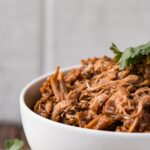 This is the BEST BBQ Pulled Pork with a mouthwatering BBQ sauce and instructions for Instant Pot and Slow Cooker. #instantpot #pulledpork #slowcooker