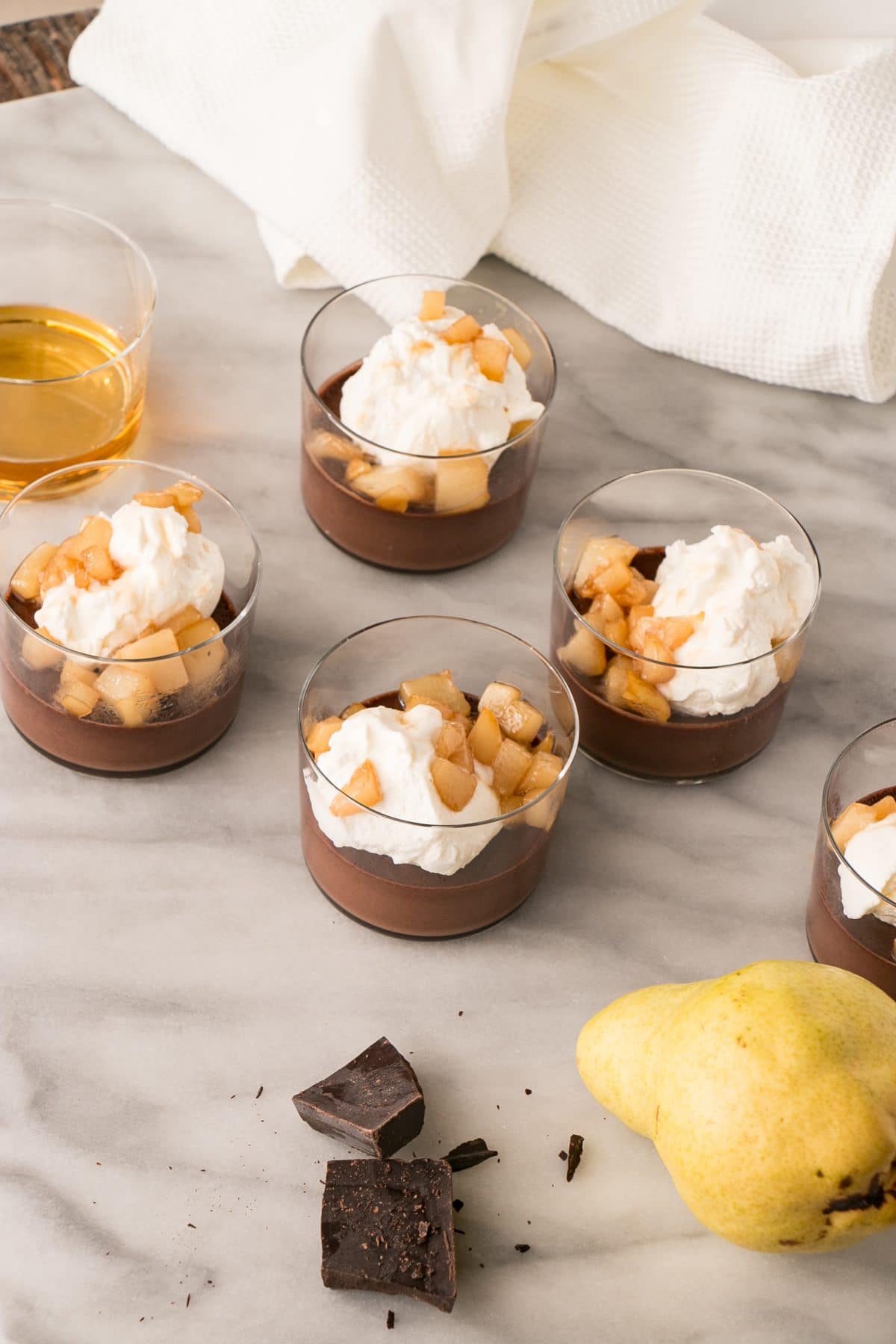 Chocolate Whiskey Pots de Creme with Caramelized Pears and Whipping Cream is an easy and decadent dessert to prepare for date night or make ahead for a showstopper of a dinner party dessert. #datenight #chocolate #dessert