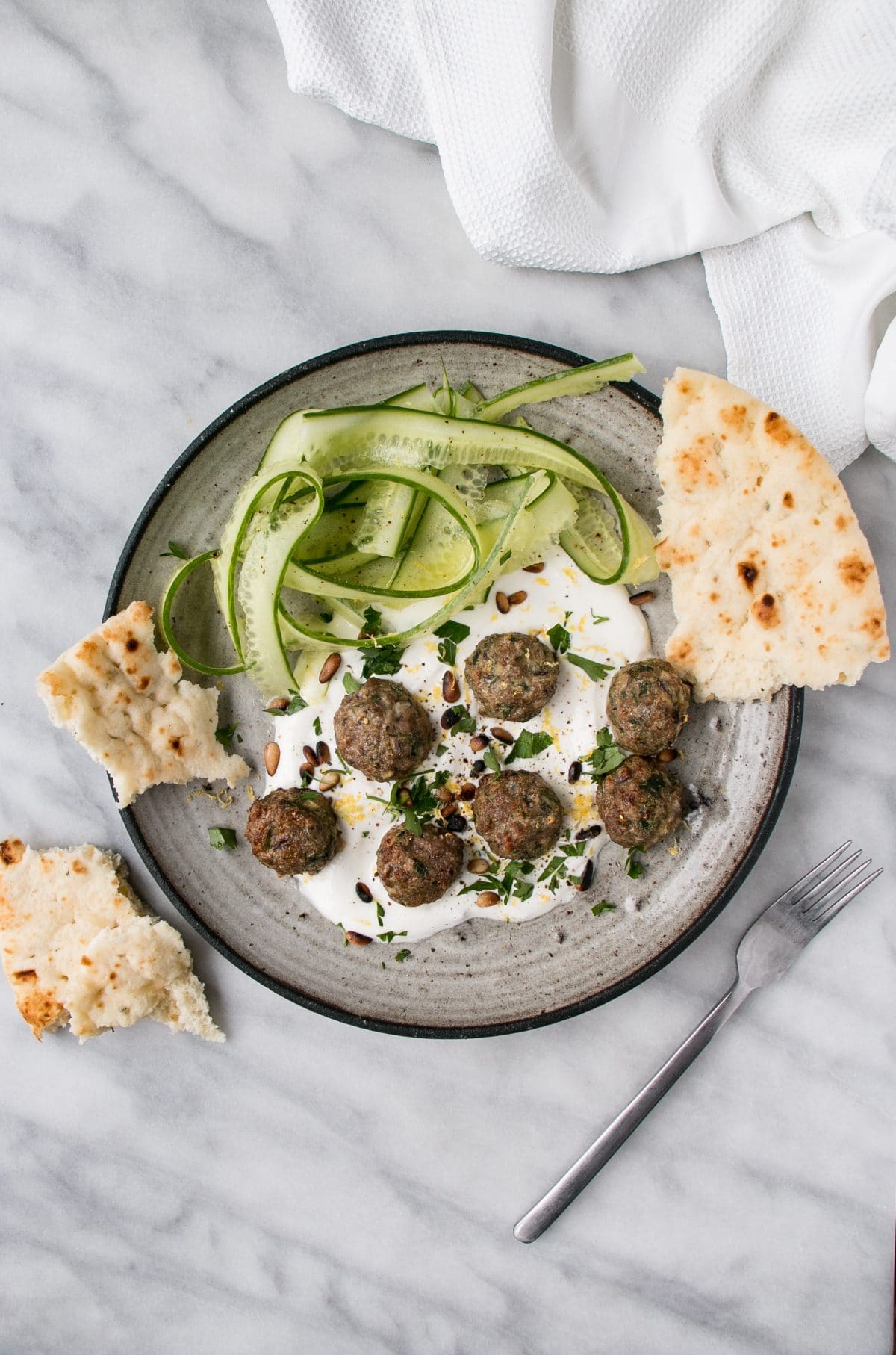 Mini Herby Lamb Meatballs are a quick and easy way to bake juicy and tasty meatballs for dinner! Serve with yogurt and cucumber salad for a refreshing supper! #meatballs #lambs #dinner #weekdaydinner