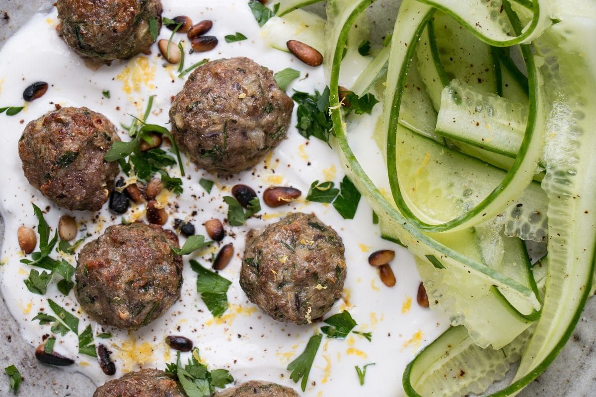 Mini Herby Lamb Meatballs are a quick and easy way to bake juicy and tasty meatballs for dinner! Serve with yogurt and cucumber salad for a refreshing supper! #meatballs #lambs #dinner #weekdaydinner