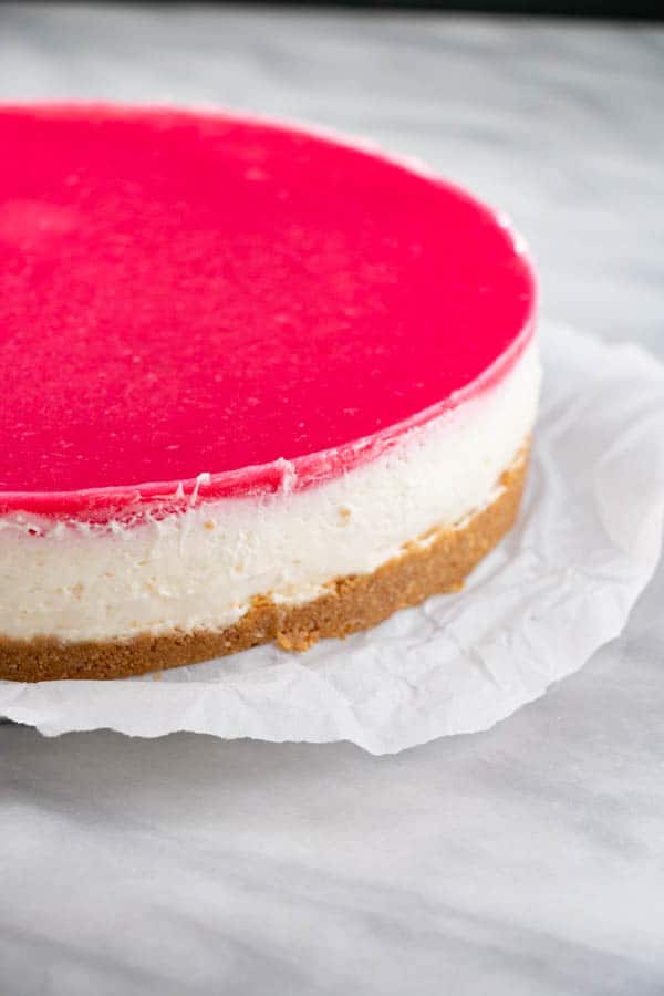 No Bake Rhubarb Cheesecake with a vibrant pink top