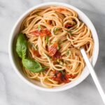 Anchovy and Tomato Pasta in a white bowl.