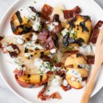 Grilled Peach, Onion and Bacon Salad on a white plate.