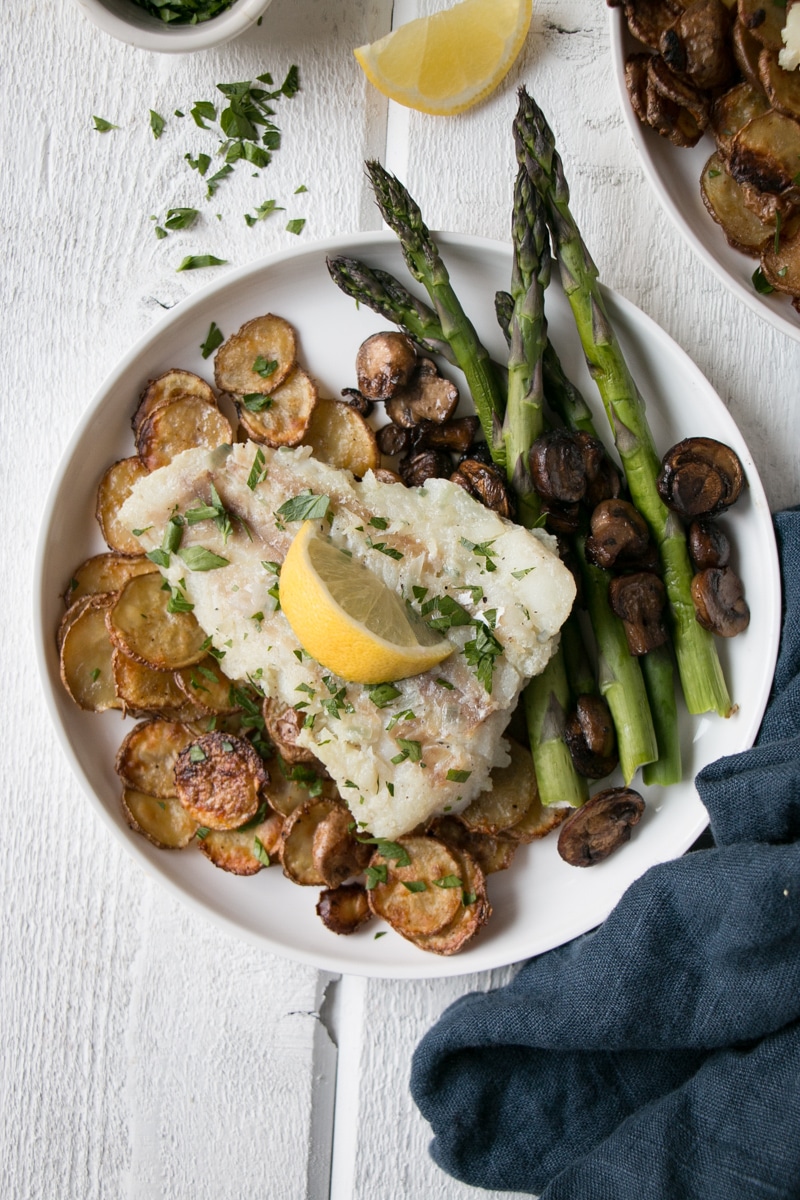 Pan Fried Cod served with potatoes, asparagus and mushrooms.