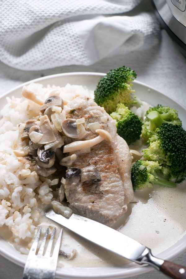 Instant Pot Pork Chops with Creamy Mushroom Gravy with rice and steamed broccoli