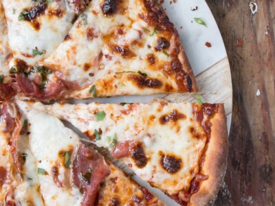 Melty cheese and crispy prosciutto pizza with bits of bright basil.