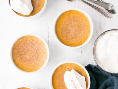 Deep golden Pumpkin Egg Custard with a dollop of whipping cream and a light sprinkle of cinnamon.