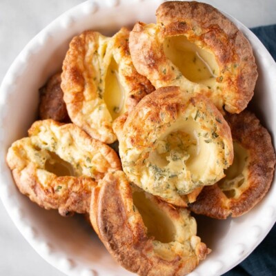 Light, fluffy and speckled with green herbs, these Yorkshire Puddings are tall having risen to the peaks of popover puffiness.