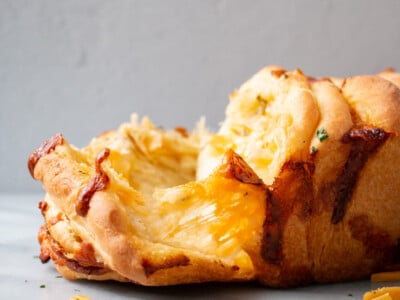 Pull Apart Cheese Bread with gooey cheese being pulled between layers.