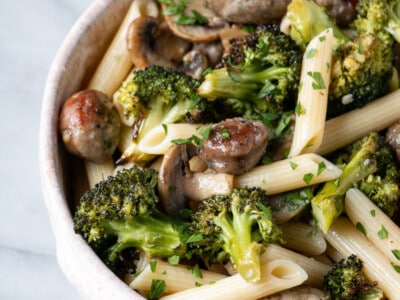 Roasted Sausage and Broccoli Pasta up close with a scattering of chopped bright green parsley on top.